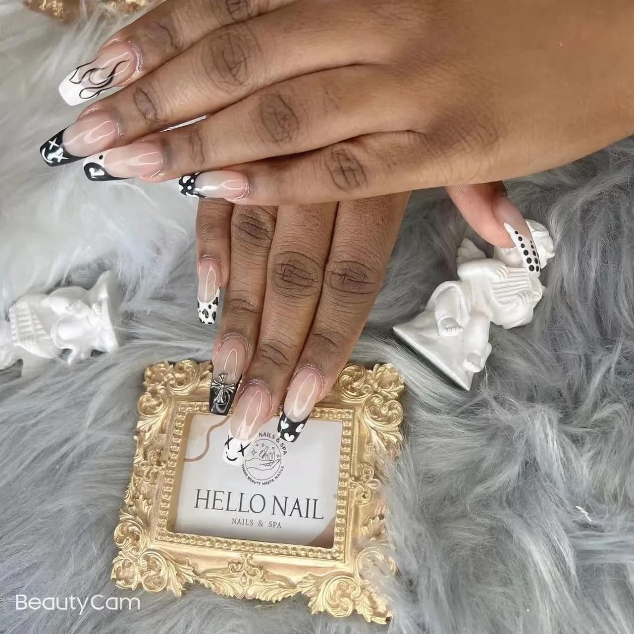 Black and white swirl French tips on almond nails
