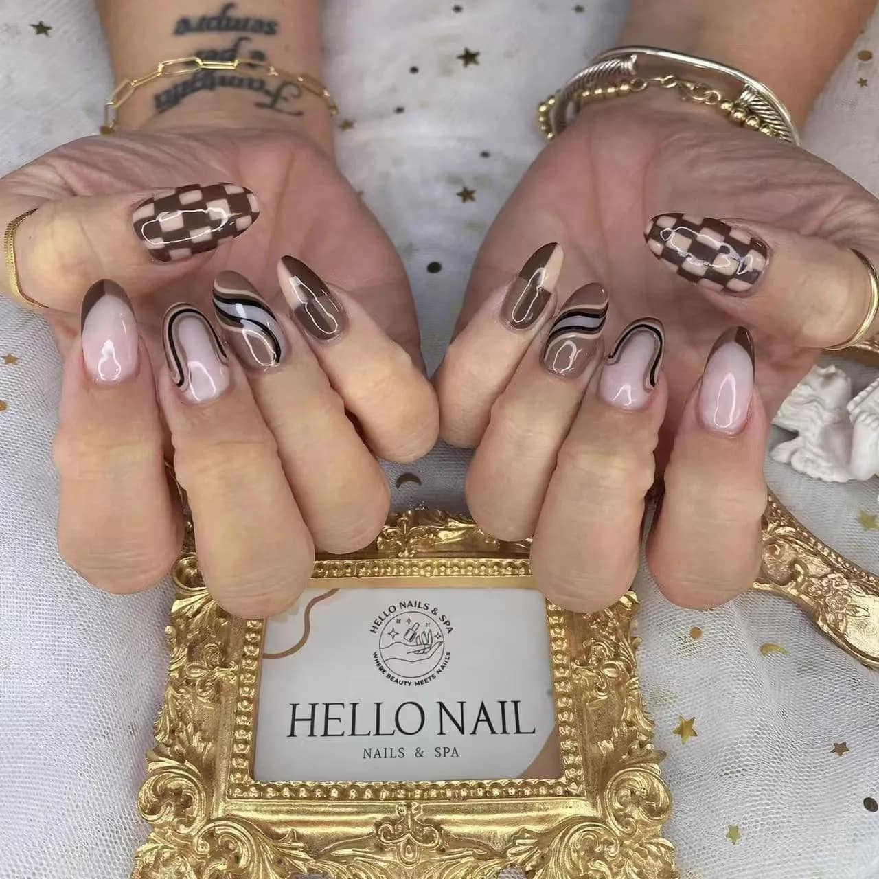 Brown checkered and swirl nail art